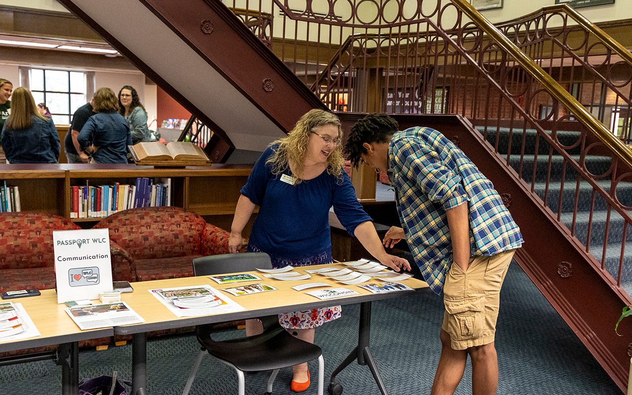 Faculty and prospective student talking at open house event